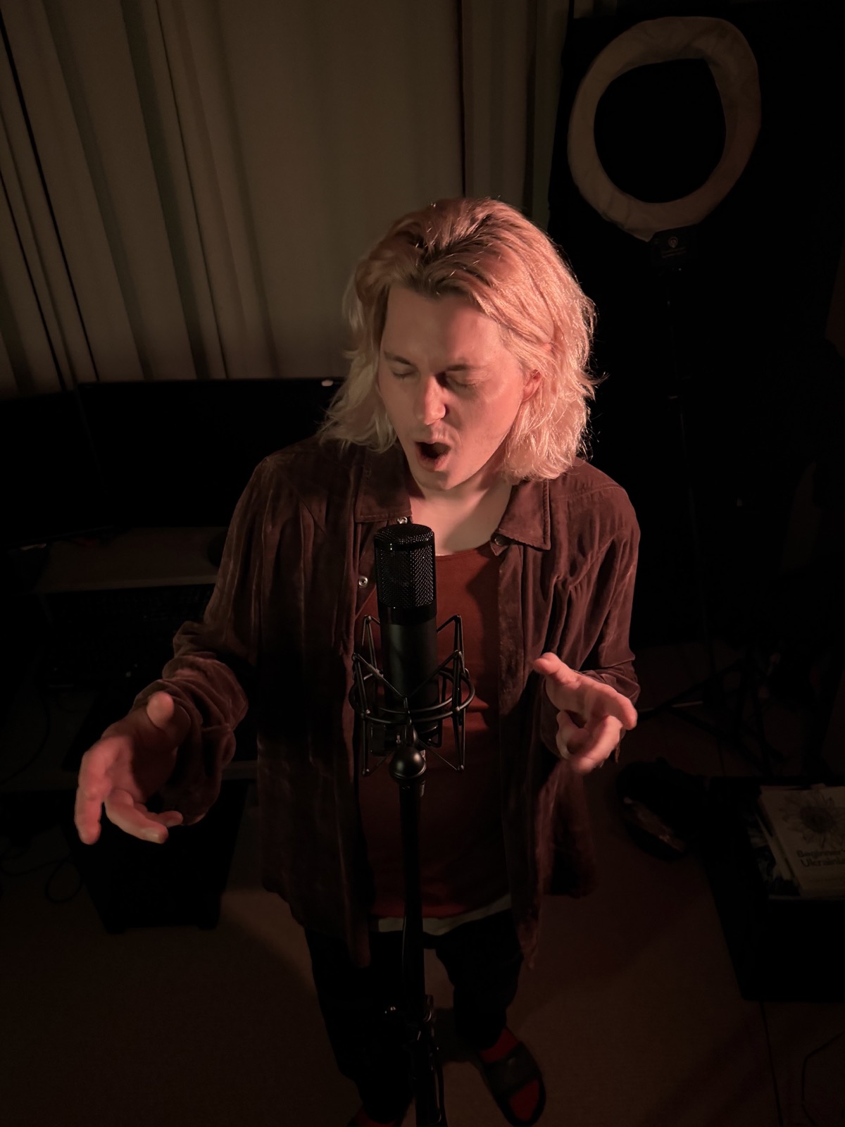 Ryan demonstrating clean singing at a studio microphone