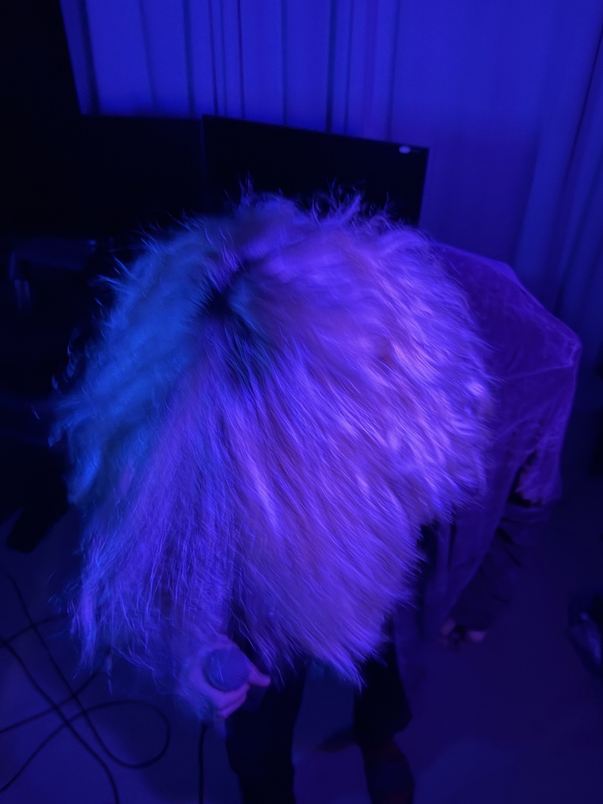 Singer moving under blue and purple studio light
